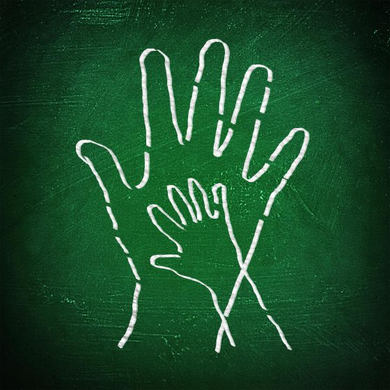 Joining hands - A child and an adult join hands on chalkboard